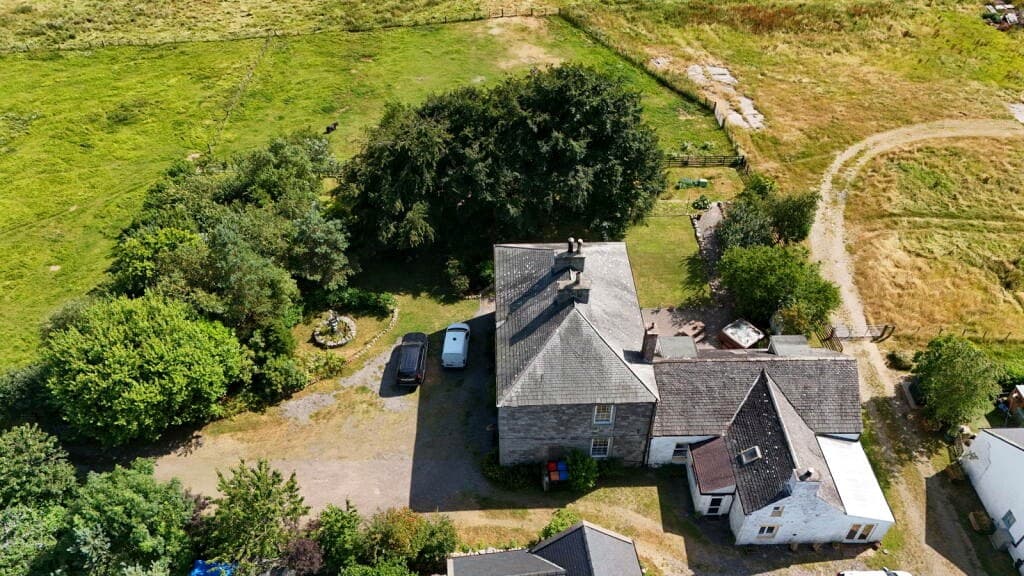 Aerial view showing Meikle Richorn on the edge of its rural hamlet
